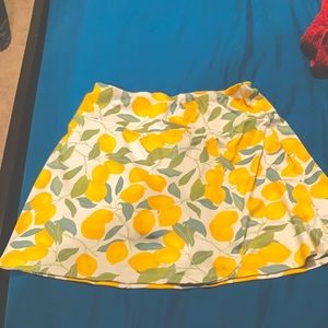 A mini skirt with shorts it has lemons all over it